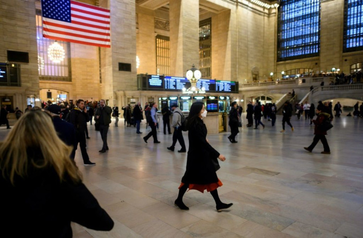 A woman walks through New York's Grand Central Station wearing a mask -- the state is one of at least 15 in the United States where cases of new coronavirus have been found