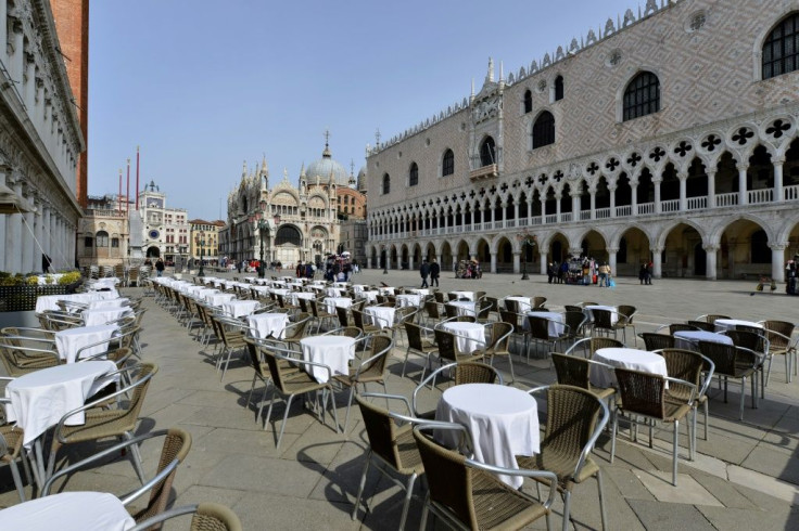 Deserted tables in front of the Doge palace in Venice, Italy