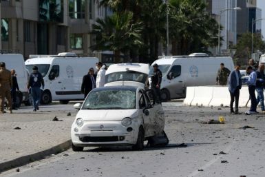 Police and forensic experts gather at the scene of an explosion near the US embassy in Tunis