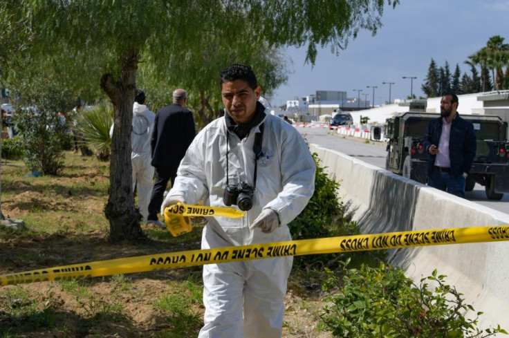 A forensic expert seals off the scene of the explosion near the US embassy in Tunis