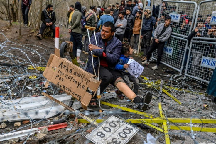 Greek officials accused Turkey of firing tear gas and smoke bombs at their border guards and providing cutters to migrants to break through fencing