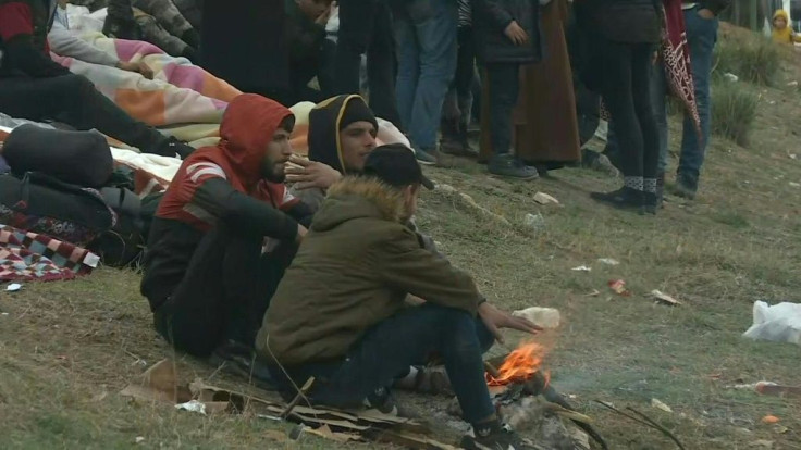Migrants wait on the Turkish side of the Greece/Turkey border near Edirne amid the ongoing migration crisis in the region.