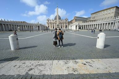 Tourists stand in St. Peter's square at the Vatican on March 6, 2020