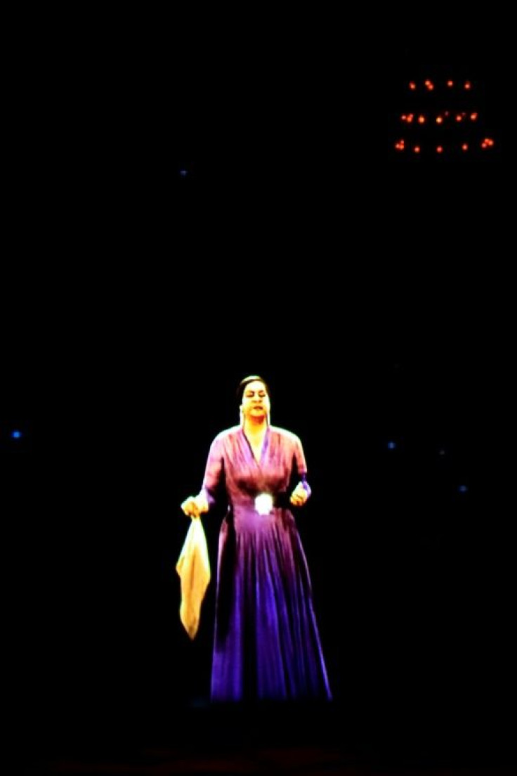 In a nod to her packed concerts of decades ago, the hologram was clad in a bright purple dress and clasped Umm Kulthum's signature handkerchief