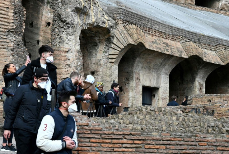 Tourists wearing masks have the Coliseum in Rome virtually to themselves as the coronavirus outbreak keeps most people away