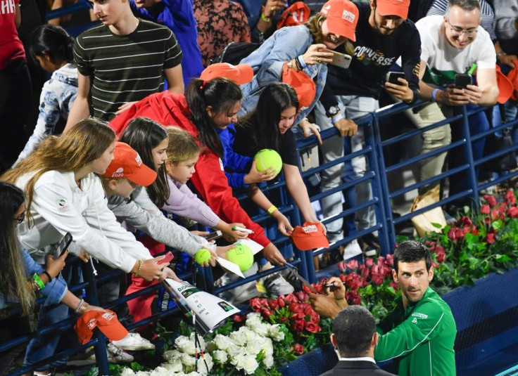 Serbia's Novak Djokovic signs autographs after winning ATP final in Dubai. The ATP and WTA tours have instructed players not to accept items to sign as part of measures to combat the spread of COVID-19