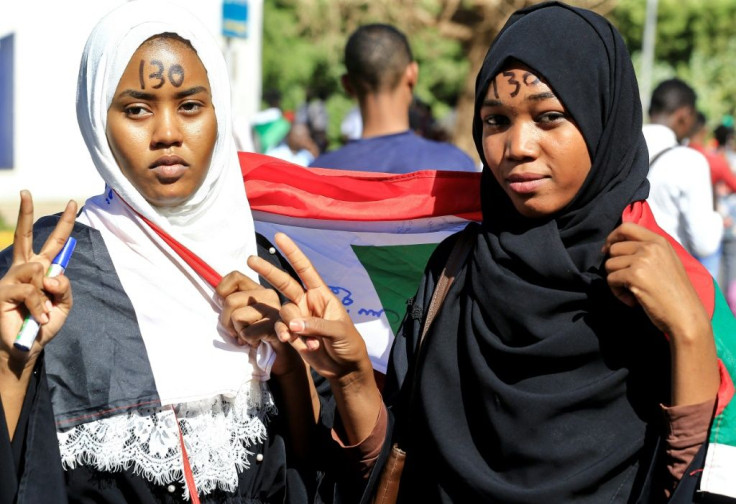 Sudanese women protesters flash the victory gesture during a demonstration in  Khartoum in late November