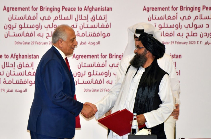The agreement signed by US negotiator Zalmay Khalilzad (L) and the Taliban's Mullah Baradar was meant to set the conditions for a complete withdrawal of foreign forces from Afghanistan within just 14 months -- and end the longest war in US history