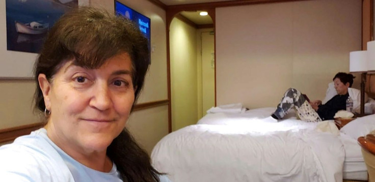 This handout photo released by Carolyn Wright, a passenger on the Grand Princess cruise ship, shows her taking a selfie alongside her friend Beryl Ward in their cabin on the ship on March 7, 2020.