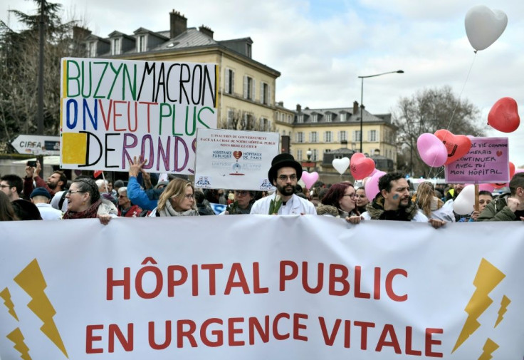 Healthcare workers dub public hospitals "a life-threatening emergency" and say "Buzyn, Macron, we want more money" in a February protest -- Macron's candidate Agnes Buzyn says Paris' condition has "deteriorated" recently