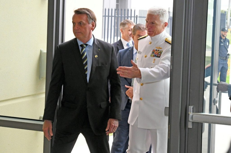 Brazilian President Jair Bolsonaro(C), is greeted by Commander, US Southern Command Admiral Craig Faller(R) in Miami, Florida on March 8, 2020; Brazil's leader was there to discuss growing bilateral defense-cooperation partnership
