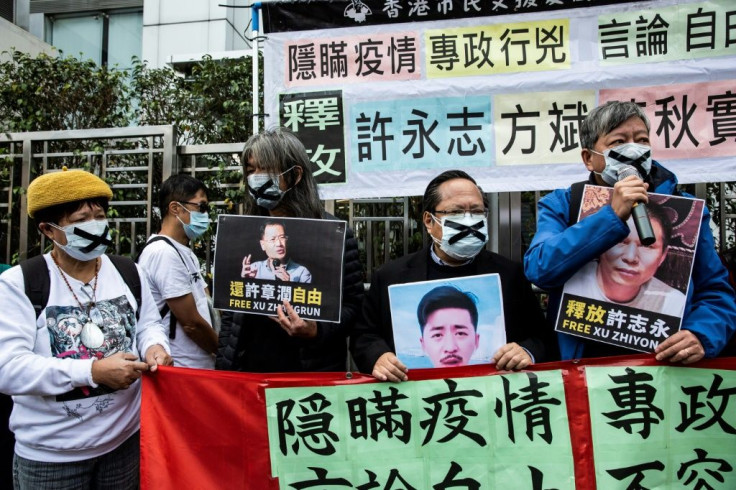 Pro-democracy protesters in Hong Kong hold placards supporting detained rights activists including Xu Zhiyong in February 2020