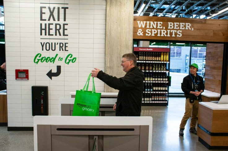 A shopper exits Amazon Go Grocery on February 26, 2020 in Seattle, Washington, the first full-sized retail grocery location that uses the cashier-free model