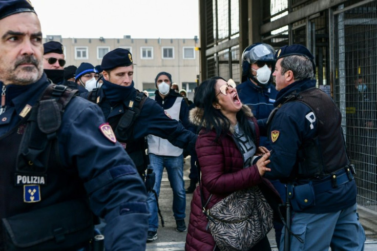 Police officers had to restrain the relatives of some inmates desperate for news of loved ones where violent protests had taken place