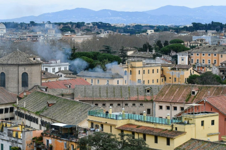 Smoke billows from a rooftop of the Regina Coeli prison in Rome