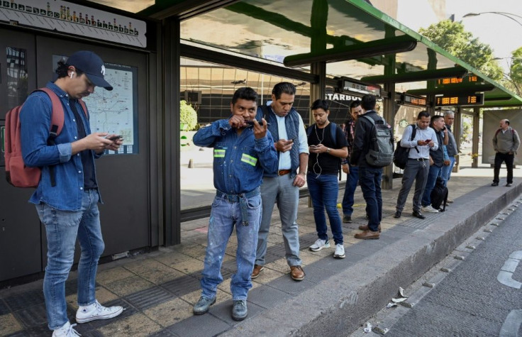 Men wait for the bus at the Hidalgo metrobus station during the Women National Strike called 'A Day Without Us' in Mexico City, on March 9, 2020