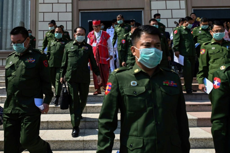 Military officers who are also members of parliament wear facemasks against the coronavirus as they leave the national assembly
