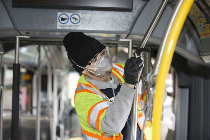 A utility service worker deep cleans a bus in Seattle, Washington state as fears of the coronavirus grow across the country