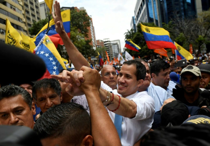 Venezuelan opposition leader Juan Guaido greets supporters during a demonstration in Caracas
