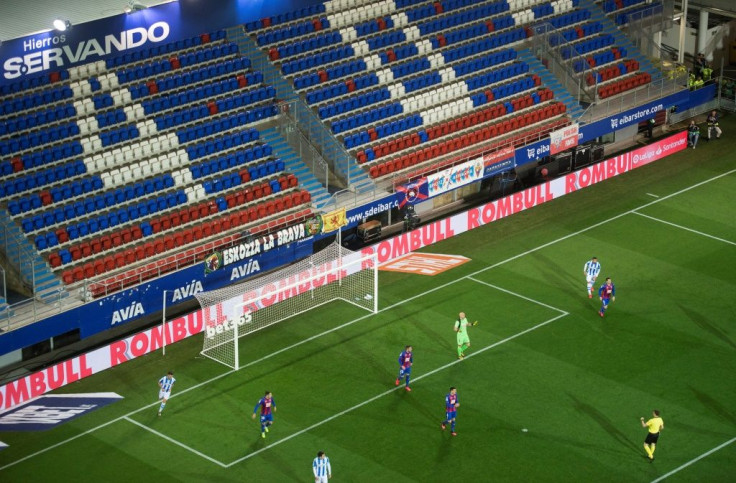 The match between Eibar and Real Sociedad, cancelled in February following a landslide into a nearby rubbish dump, on Tuesday became the first Liga game played behind closed doors because of coronavirus