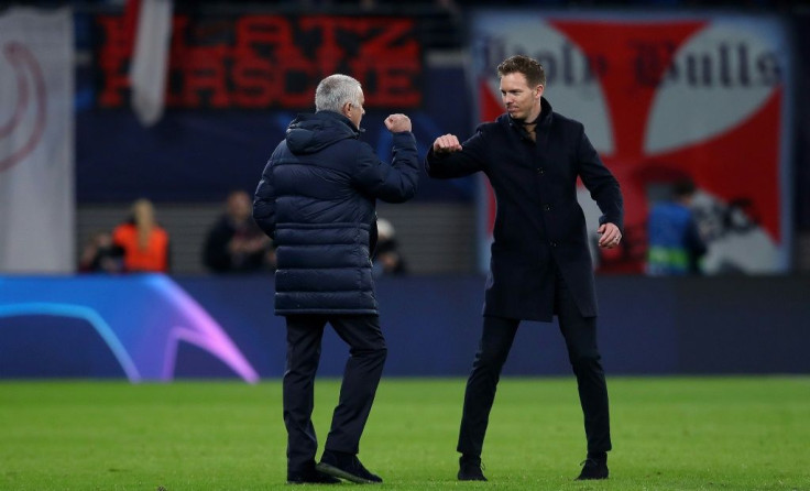Julian Nagelsmann (R) and Jose Mourinho "elbow bump" after the UEFA Champions League match between RB Leipzig and Tottenham Hotspur, in Leipzig