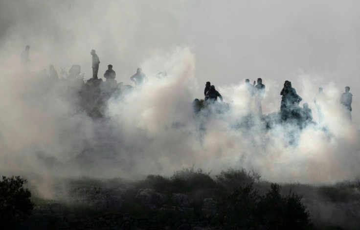 Young Palestinians brave Israeli tear gas to demonstrate against a rumoured land seizure near the northern West Bank city of Nablus