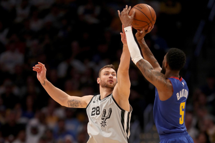  Will Barton #5 of the Denver Nuggets puts up a shot over Donatas Motiejunas #28 of the San Antonio Spurs