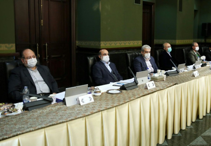 Iran's cabinet meets with ministers all wearing face masks in a bid to stem the spread of the coronavirus