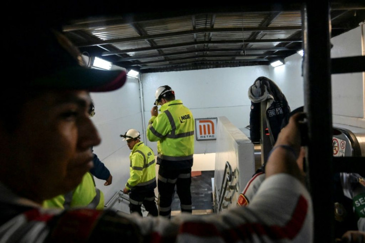 Subway staff enter Tacubaya station in Mexico City after two trains collided