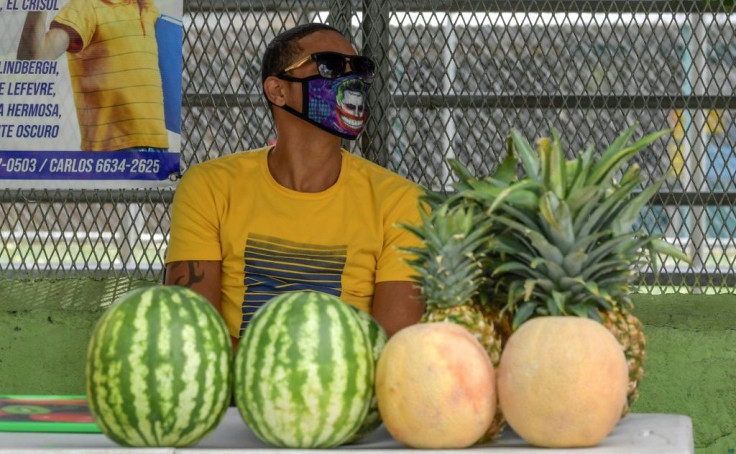 A street vendor sells fruit in Panama City while wearing a mask to protect against the coronavirus