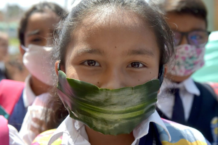 A student in Soacha, Colombia wears a mask made of recyclable and biodegradable materials as a form of protest against the shortage of face masks in pharmacies against the coronavirus