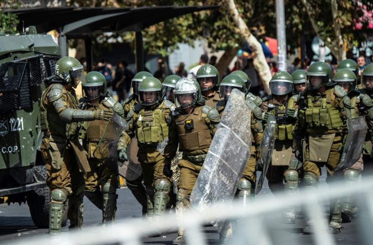Chilean riot police take position during a protest against President Sebastian Pinera on the second anniversary of his inuguration in Santiago on March 11, 2020.