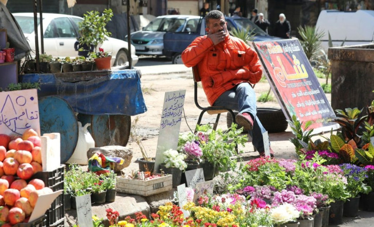 Syrian residents of Damascus like florist Abdelqader Qasem are still struggling to rebuild their lives as the conflict that has devastated the country enters its 10th year