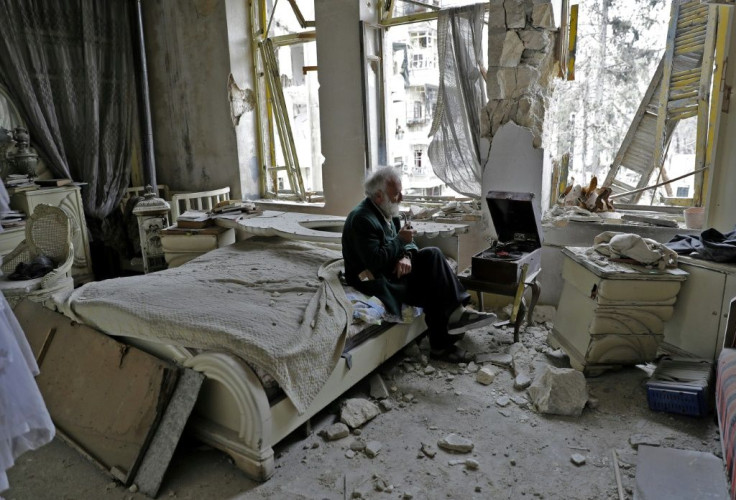 A Syrian man smokes his pipe in his destroyed bedroom in Aleppo's formerly rebel-held Shaar neighbourhood on March 9, 2017