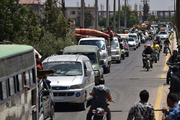 Displaced Syrians from the Daraa province travel back to their hometown in Busra, southwestern Syria, on July 11, 2018