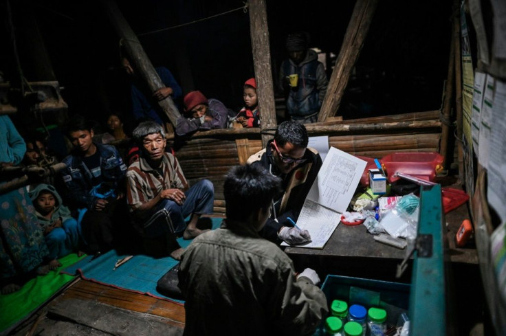 The monthly mobile clinic run by doctors who arrive on motorbikes runs late into the night in the isolated village