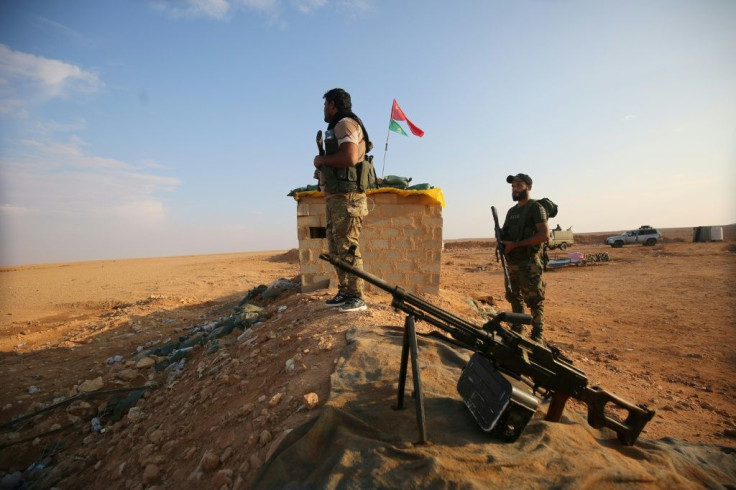 Shiite paramilitaries of Iraq's Hashed al-Shaabi force patrol the border area near the Syrian town of Albu Kamal where 26 of their comreades were killed in an air strike