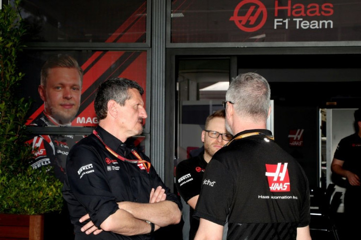 Haas F1 team principal Guenther Steiner (left) talks with team members at Albert Park after four members of staff went into isolation over coronavirus fears