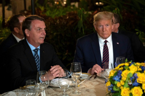(FILES) In this file photo US President Donald Trump (R) speaks with Brazilian President Jair Bolsonaro during a dinner at Mar-a-Lago in Palm Beach, Florida, on March 7, 2020