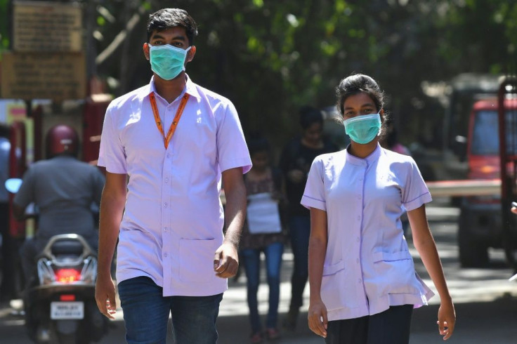 Medical staff wearing facemasks amid concerns of the spread of the coronavirus leave a hospital in Mumbai on March 12