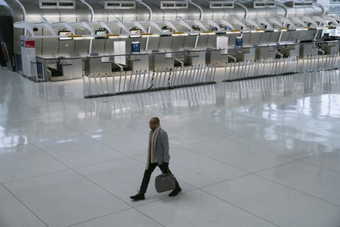 A man walks past the Air France counter at John F. Kennedy International Airport in New York