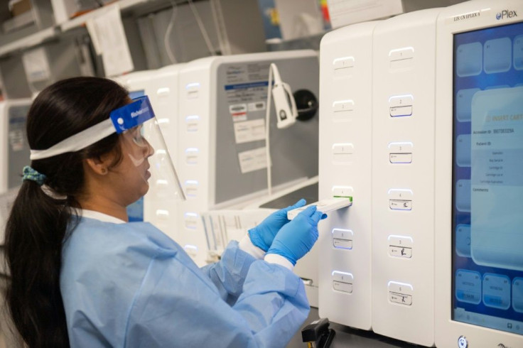 A lab technician begins semi-automated testing for COVID-19 at Northwell Health Labs in Lake Success, New York