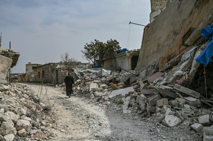 A man walks in al-Mastuma, about seven kilometres south of Idlib city in northwest Syria, on March 10