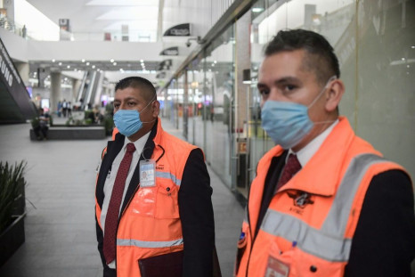 Employees wear face masks at  Mexico City International Airport. Several Latin American states have tightened travel restrictions due to the coronavirus outbreak