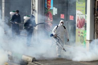 Iranian firefighters and municipality workers disinfect streets in the capital Tehran in a bid to halt the wild spread of coronavirus