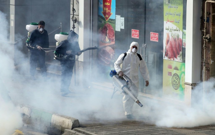 Iranian firefighters and municipality workers disinfect streets in the capital Tehran in a bid to halt the wild spread of coronavirus