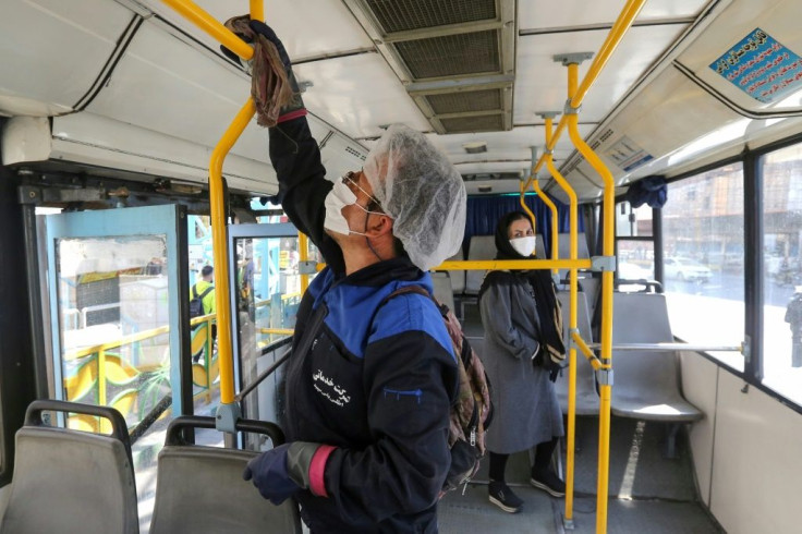 A municipality worker cleans a bus in Tehran to halt the the spread of coronavirus