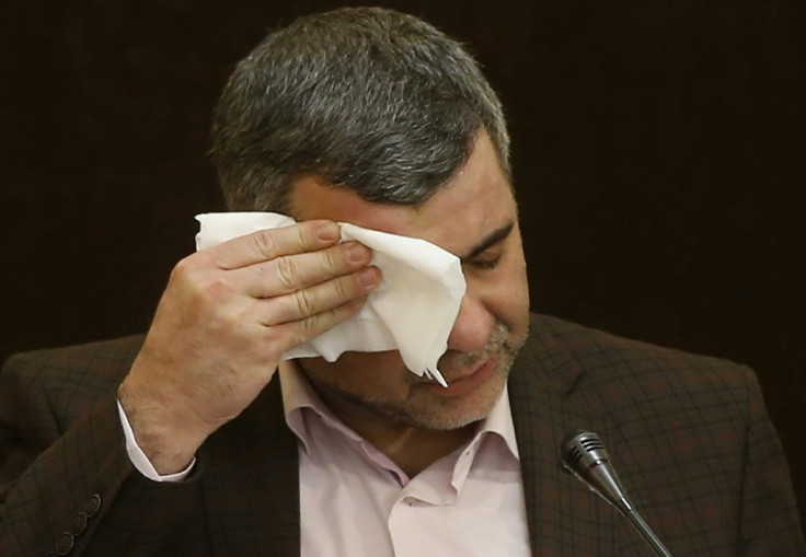 Iranian Deputy Health Minister Iraj Harirchi wipes the sweat off his face during a February 2020 news conference before testing positive for the novel coronavirus