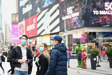 People wearing masks visit New York's Times Square on March 14, 2020