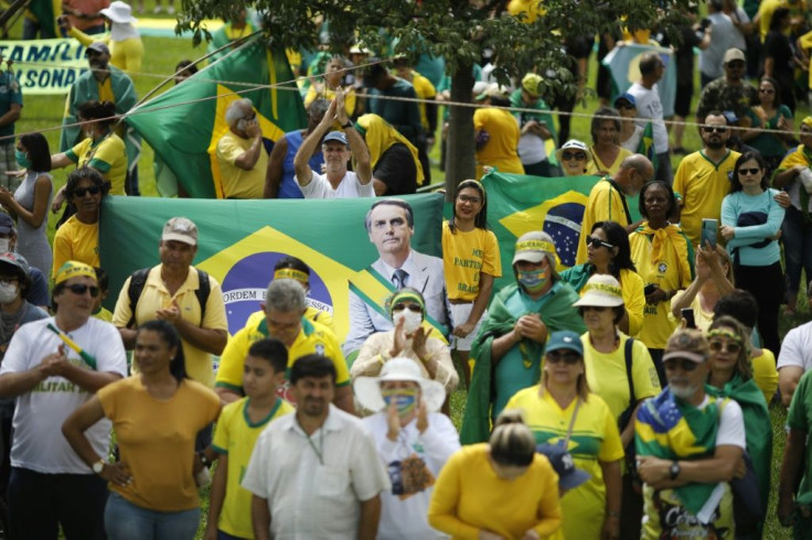 Supporters of the Brazilian President Jair Bolsonaro take part in a protest against the National Congress and the Supreme Court while wearing protective face masks to prevent the spread of the new Coronavirus, COVID-19, in Brasilia, on March 15, 2020